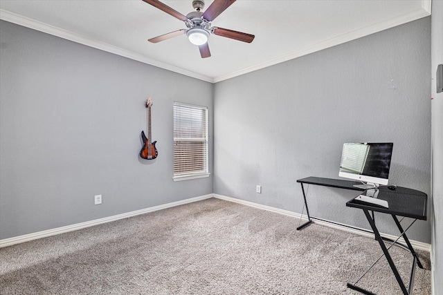 unfurnished office with carpet floors, ornamental molding, baseboards, and ceiling fan