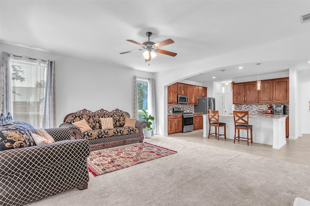 2317 Willard Dr, Mckinney, TX 75072 - living area featuring a ceiling fan, arched walkways, recessed lighting, and light colored carpet