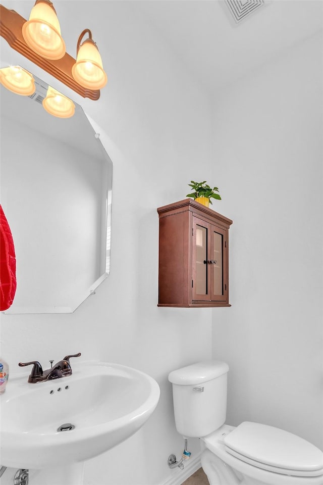 2317 Willard Dr, Mckinney, TX 75072 - bathroom with a sink, toilet, and baseboards