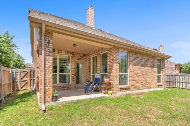 2317 Willard Dr, Mckinney, TX 75072 - back of house featuring a chimney, brick siding, and a patio
