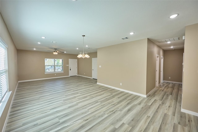 unfurnished room with recessed lighting, light wood-style flooring, baseboards, a chandelier, and a ceiling fan