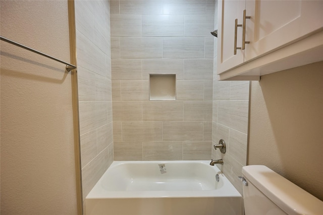 1224 W Bewick St, Fort Worth, TX 76110 - bathroom featuring toilet, a textured wall, and bathing tub / shower combination