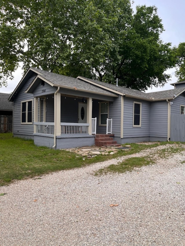 2345 Laughlin Dr, Dallas, TX 75228 - ranch-style home featuring a porch, gravel driveway, and a shingled roof