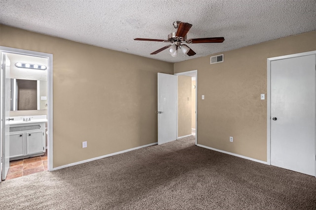 628 Evelyn Ln, Burleson, TX 76028 - unfurnished bedroom featuring carpet flooring, a textured ceiling, a ceiling fan, ensuite bathroom, and visible vents