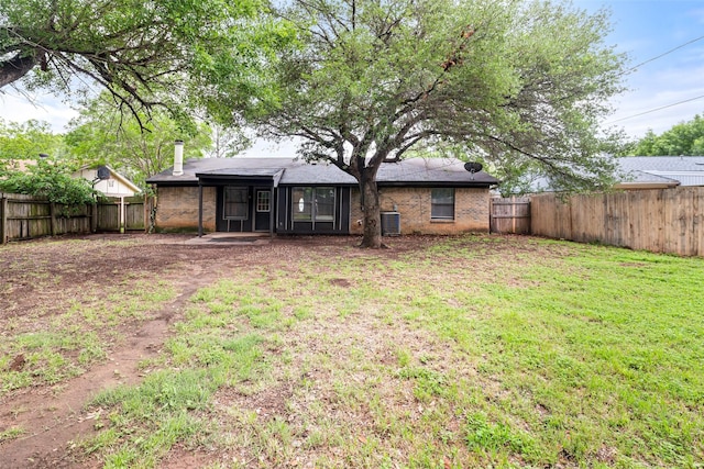 628 Evelyn Ln, Burleson, TX 76028 - back of house with a fenced backyard, a sunroom, a lawn, and brick siding