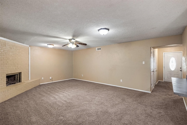 628 Evelyn Ln, Burleson, TX 76028 - unfurnished living room featuring a textured ceiling, carpet, ceiling fan, and a fireplace
