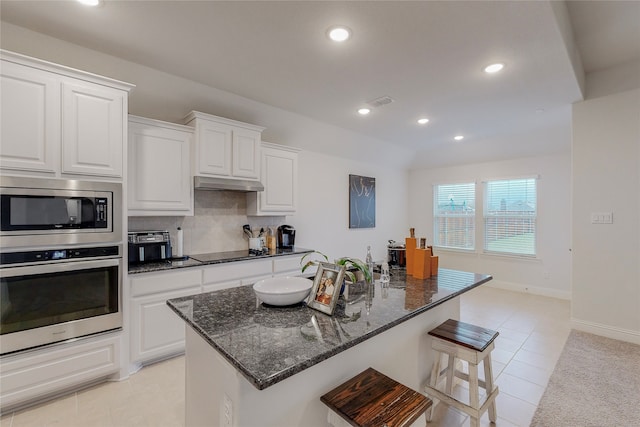 537 Val Verde St, Aubrey, TX 76227 - kitchen with appliances with stainless steel finishes, light tile patterned floors, dark stone countertops, under cabinet range hood, and recessed lighting