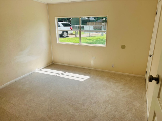 empty room with baseboards and carpet