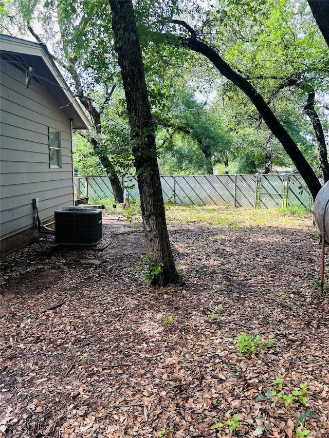 view of yard featuring fence and cooling unit