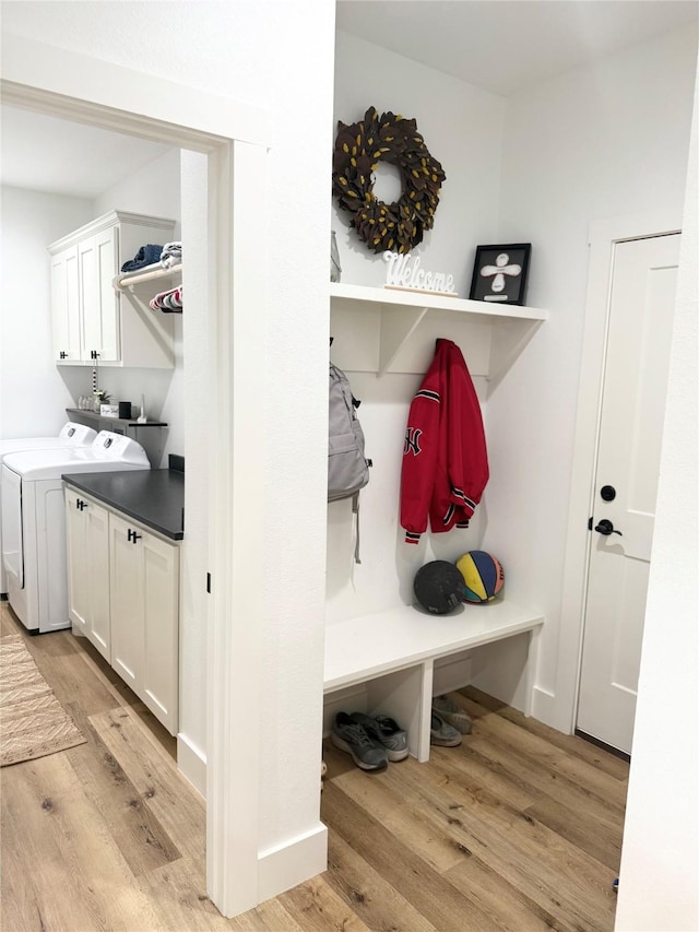 mudroom featuring light wood-style floors and washing machine and clothes dryer