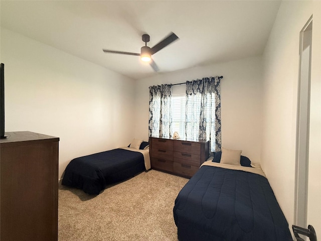 bedroom with a ceiling fan and light colored carpet
