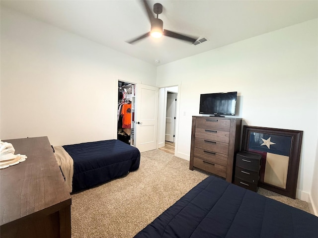bedroom featuring a walk in closet, a ceiling fan, visible vents, carpet floors, and a closet