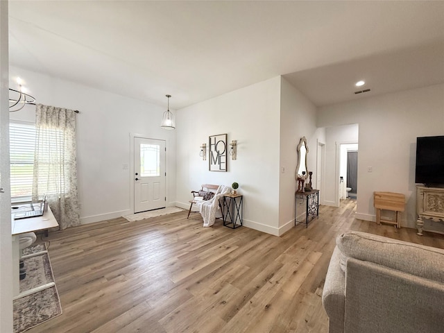 living room featuring recessed lighting, baseboards, visible vents, and light wood-style floors