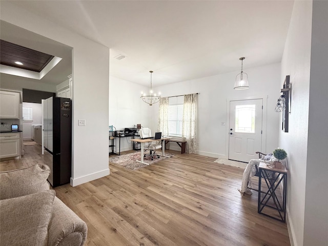 dining room with visible vents, baseboards, an inviting chandelier, and light wood finished floors