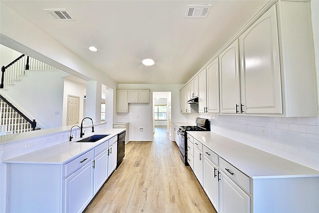2328 Twilight Star Dr, Little Elm, TX 75068 - kitchen with gas range, a sink, dishwasher, under cabinet range hood, and light wood-type flooring