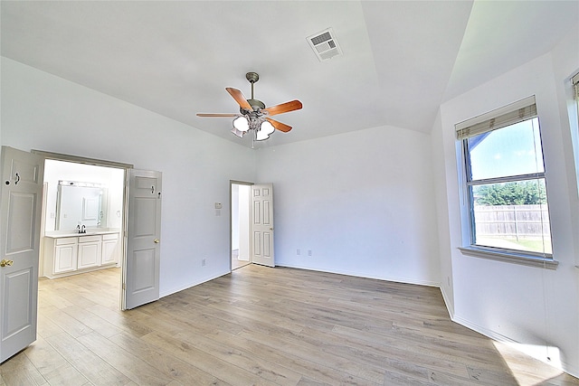 2328 Twilight Star Dr, Little Elm, TX 75068 - unfurnished bedroom featuring vaulted ceiling, light wood-style flooring, a sink, baseboards, and connected bathroom