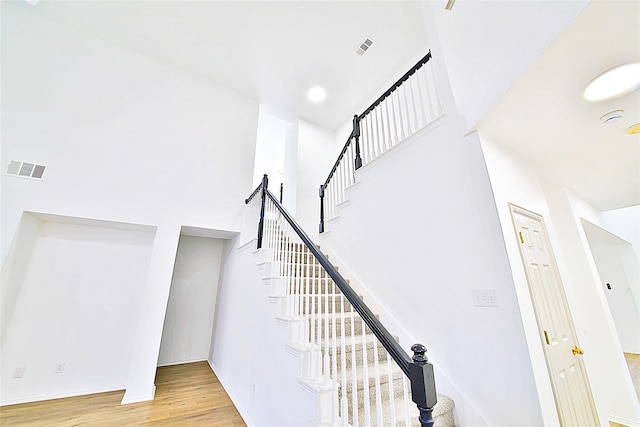 2328 Twilight Star Dr, Little Elm, TX 75068 - staircase with wood finished floors, a high ceiling, and baseboards