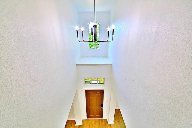 2328 Twilight Star Dr, Little Elm, TX 75068 - foyer entrance featuring a chandelier, light wood-type flooring, and a towering ceiling