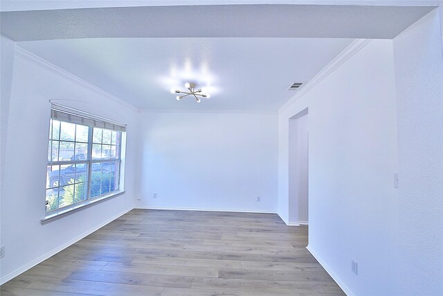 2328 Twilight Star Dr, Little Elm, TX 75068 - empty room featuring crown molding, wood finished floors, baseboards, and a chandelier