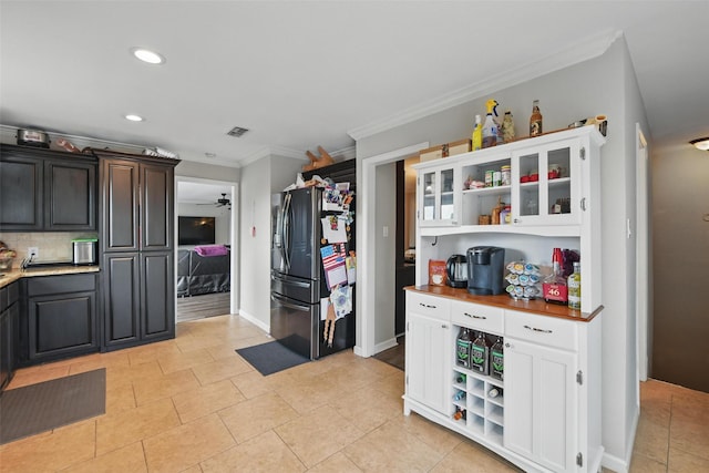 kitchen with crown molding, open shelves, visible vents, stainless steel fridge, and recessed lighting