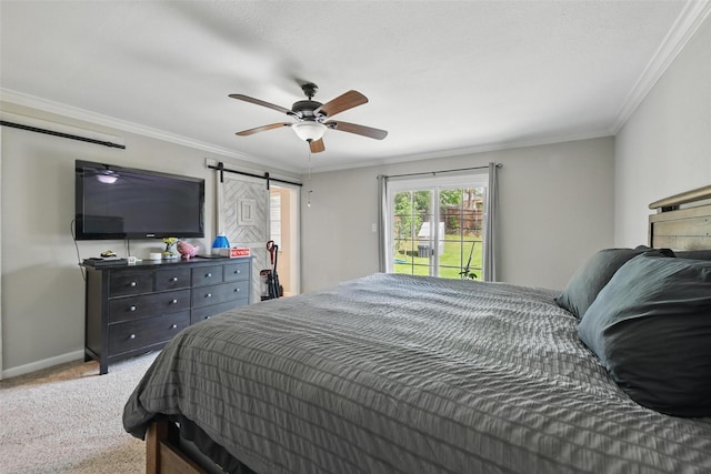 carpeted bedroom with access to outside, baseboards, a barn door, and ornamental molding
