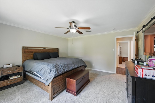 bedroom with visible vents, crown molding, light colored carpet, a barn door, and baseboards