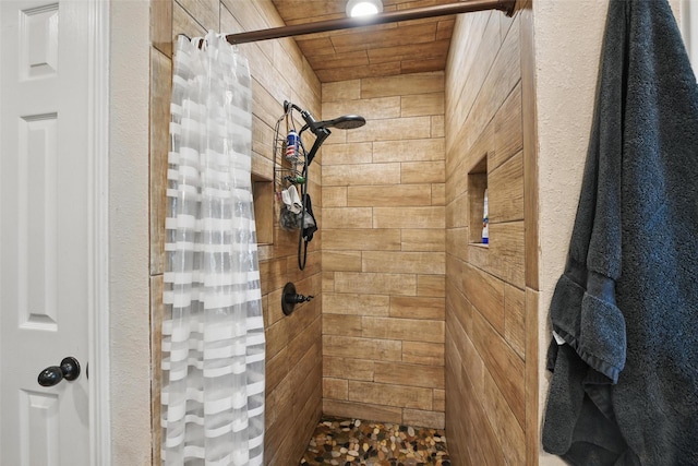 bathroom with tiled shower