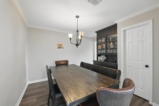dining area with visible vents, crown molding, baseboards, a notable chandelier, and dark wood-type flooring