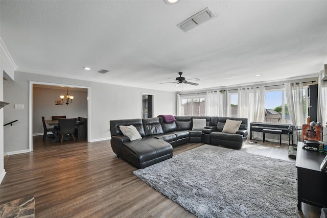 living area with a textured ceiling, visible vents, a wealth of natural light, and wood finished floors