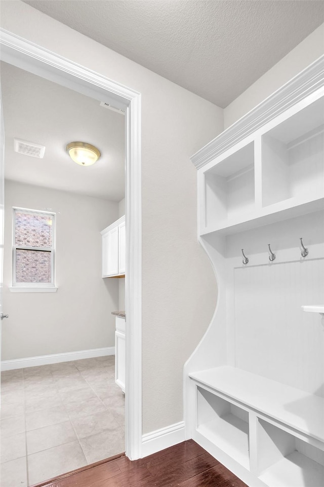 3020 Nyala Trl, Frisco, TX 75034 - mudroom with visible vents, a textured ceiling, and baseboards