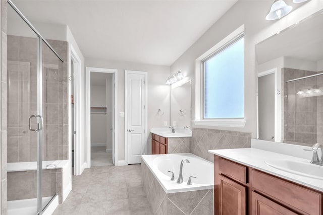 3020 Nyala Trl, Frisco, TX 75034 - bathroom featuring a walk in closet, a bath, two vanities, a shower stall, and a sink