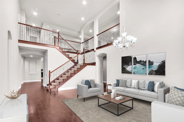 3020 Nyala Trl, Frisco, TX 75034 - living area with arched walkways, a high ceiling, stairs, and wood finished floors