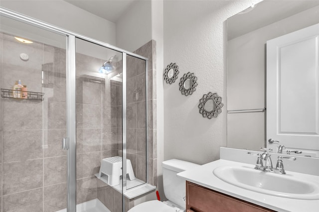 3020 Nyala Trl, Frisco, TX 75034 - bathroom featuring vanity, a textured wall, toilet, and a shower stall