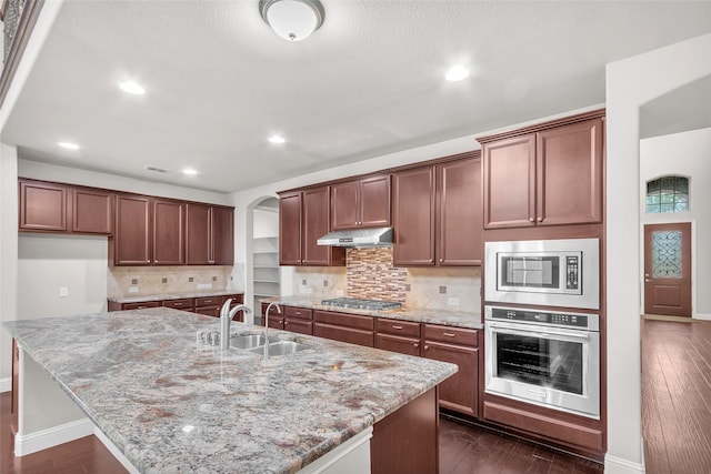 3020 Nyala Trl, Frisco, TX 75034 - kitchen with a sink, light stone counters, baseboards, and stainless steel appliances