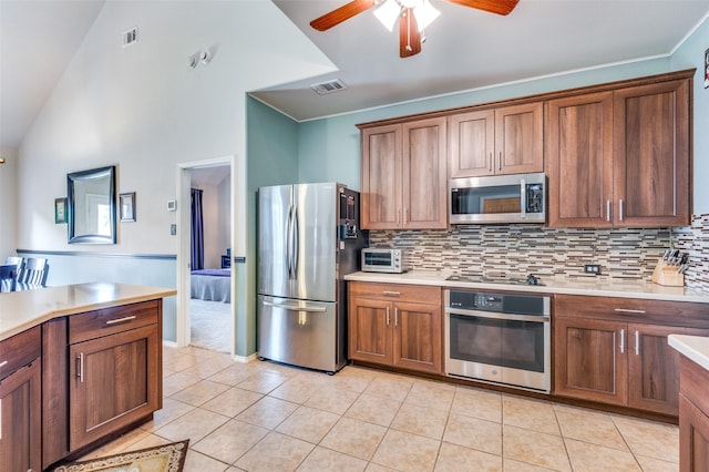 kitchen with visible vents, light countertops, a ceiling fan, light tile patterned floors, and stainless steel appliances