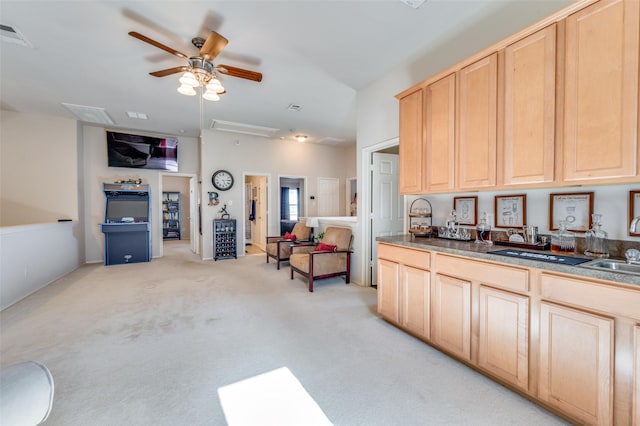 kitchen featuring a ceiling fan, visible vents, light colored carpet, open floor plan, and light brown cabinets