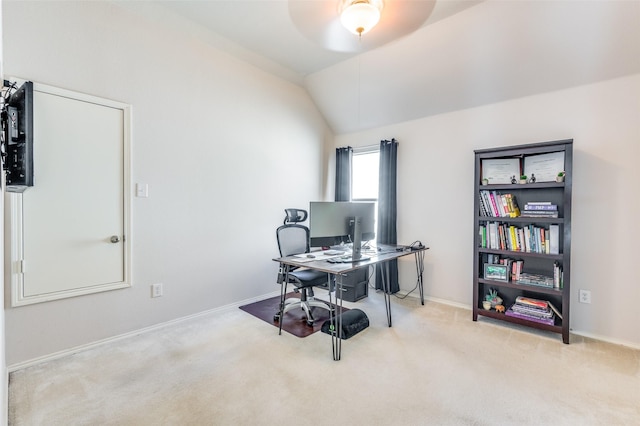 carpeted office space with ceiling fan, vaulted ceiling, and baseboards
