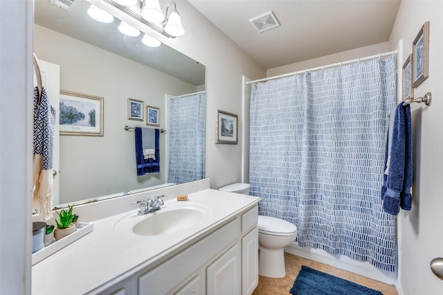 bathroom featuring visible vents, vanity, toilet, a shower with shower curtain, and tile patterned floors