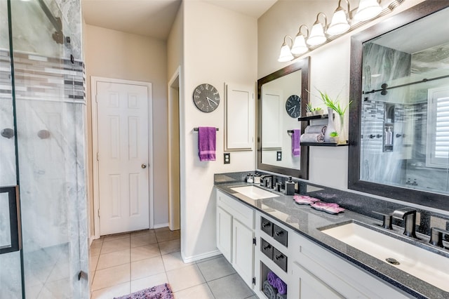 bathroom with a sink, tile patterned flooring, a stall shower, and double vanity