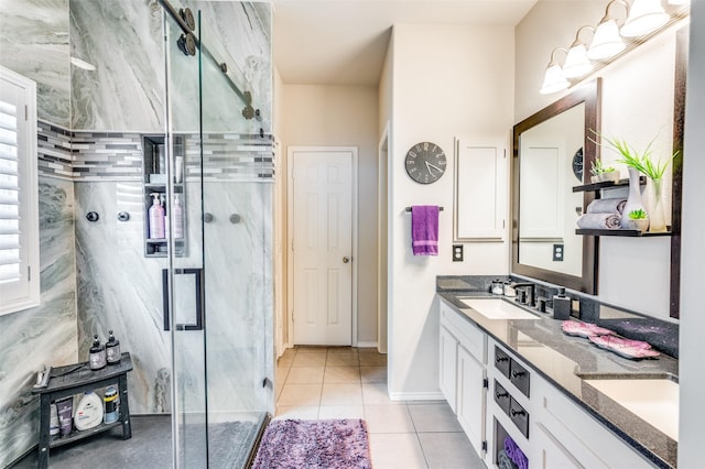 bathroom with tile patterned flooring, a sink, a stall shower, and double vanity