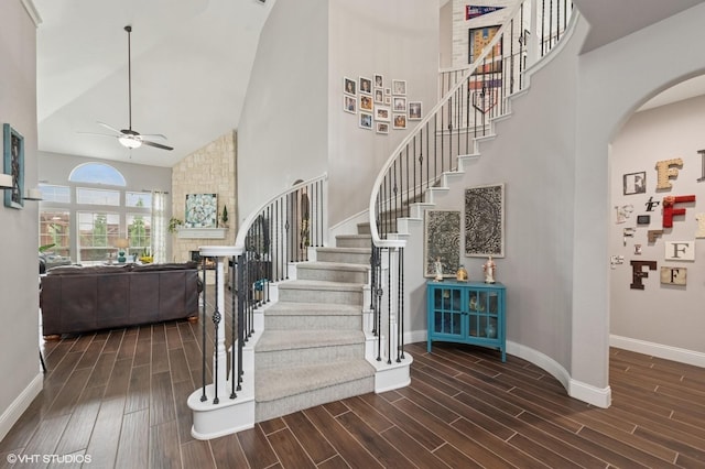 13283 Bodega Trl, Frisco, TX 75035 - stairway with wood finished floors, baseboards, ceiling fan, high vaulted ceiling, and arched walkways