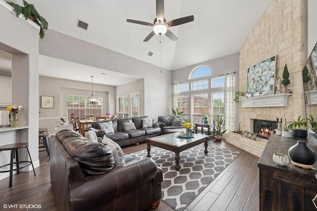13283 Bodega Trl, Frisco, TX 75035 - living area with a fireplace, high vaulted ceiling, a ceiling fan, dark wood-type flooring, and visible vents