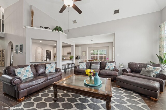 13283 Bodega Trl, Frisco, TX 75035 - living room with arched walkways, a ceiling fan, wood finished floors, and visible vents