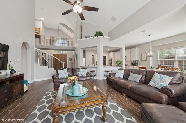 13283 Bodega Trl, Frisco, TX 75035 - living area featuring baseboards, wood tiled floor, ceiling fan, stairway, and arched walkways