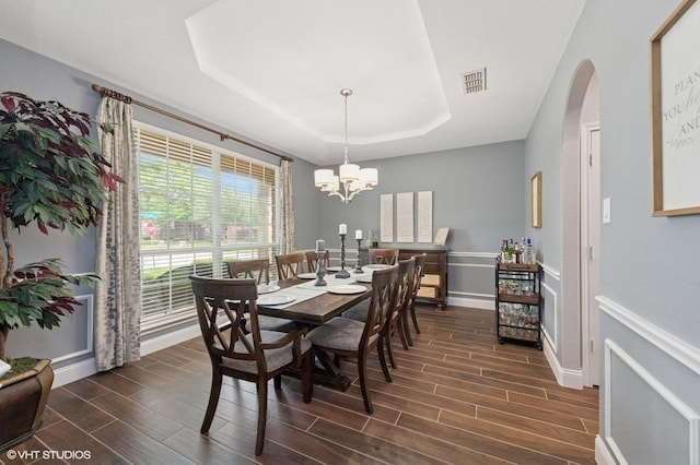 13283 Bodega Trl, Frisco, TX 75035 - dining space featuring visible vents, dark wood-style flooring, a notable chandelier, and a tray ceiling