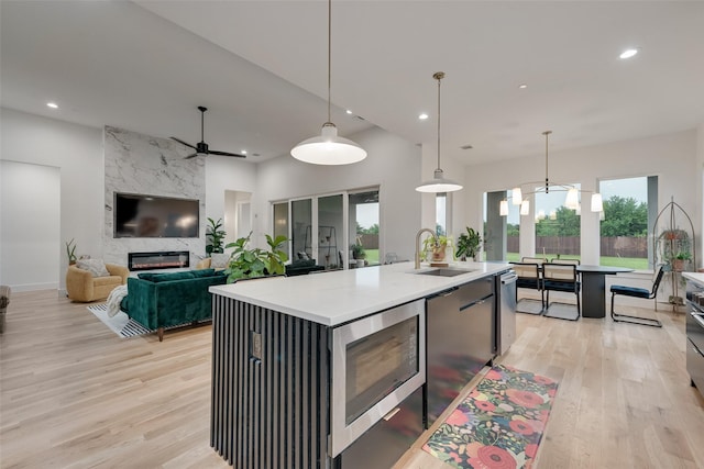 kitchen with recessed lighting, a sink, and light wood finished floors