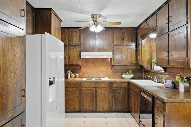 kitchen featuring white appliances, under cabinet range hood, a ceiling fan, light tile patterned flooring, and a textured ceiling