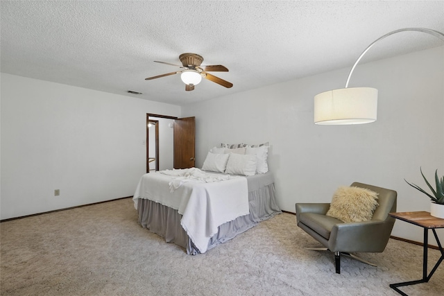 bedroom featuring carpet floors, a ceiling fan, a textured ceiling, and baseboards