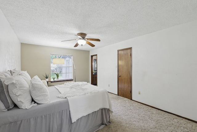 bedroom with carpet floors, ceiling fan, a textured ceiling, and baseboards