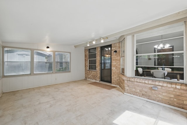 unfurnished sunroom with a chandelier